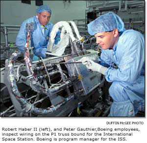 Inspecting wiring on the P1 truss bound for the ISS